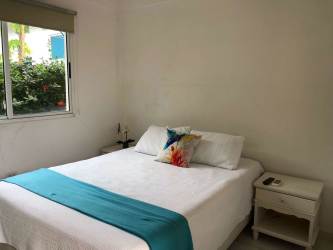 Spacious roofed terrace with outdoor dining table next to pool at Coronado beach house rental