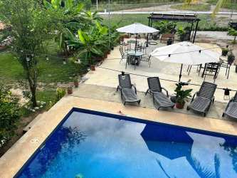 Large living area with sofas, TV, and ceiling fans, perfect for family and group gatherings near Coronado beach Panama