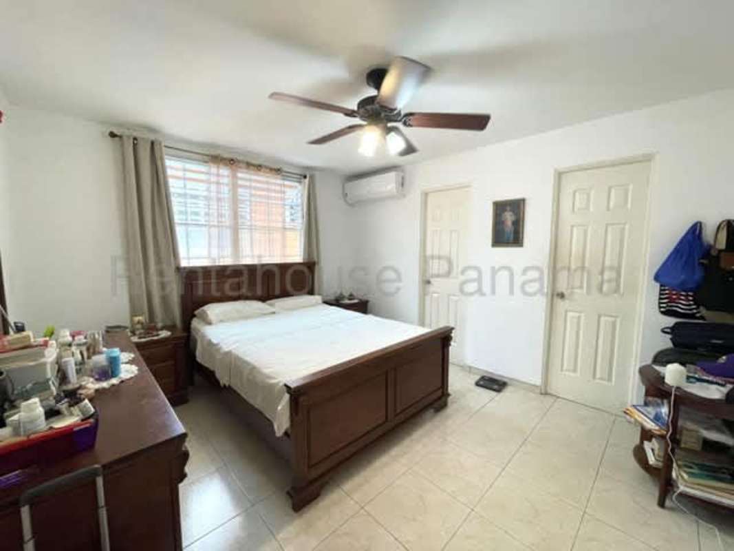 Bedroom in classic style with tile flooring, AC unit, and ceiling fan located in Brisas del Golf II Panama