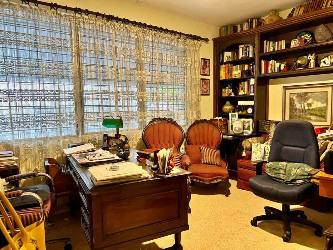 Open layout with red chairs, classic furnishings, wall art — Panama family home in Hato Pintado