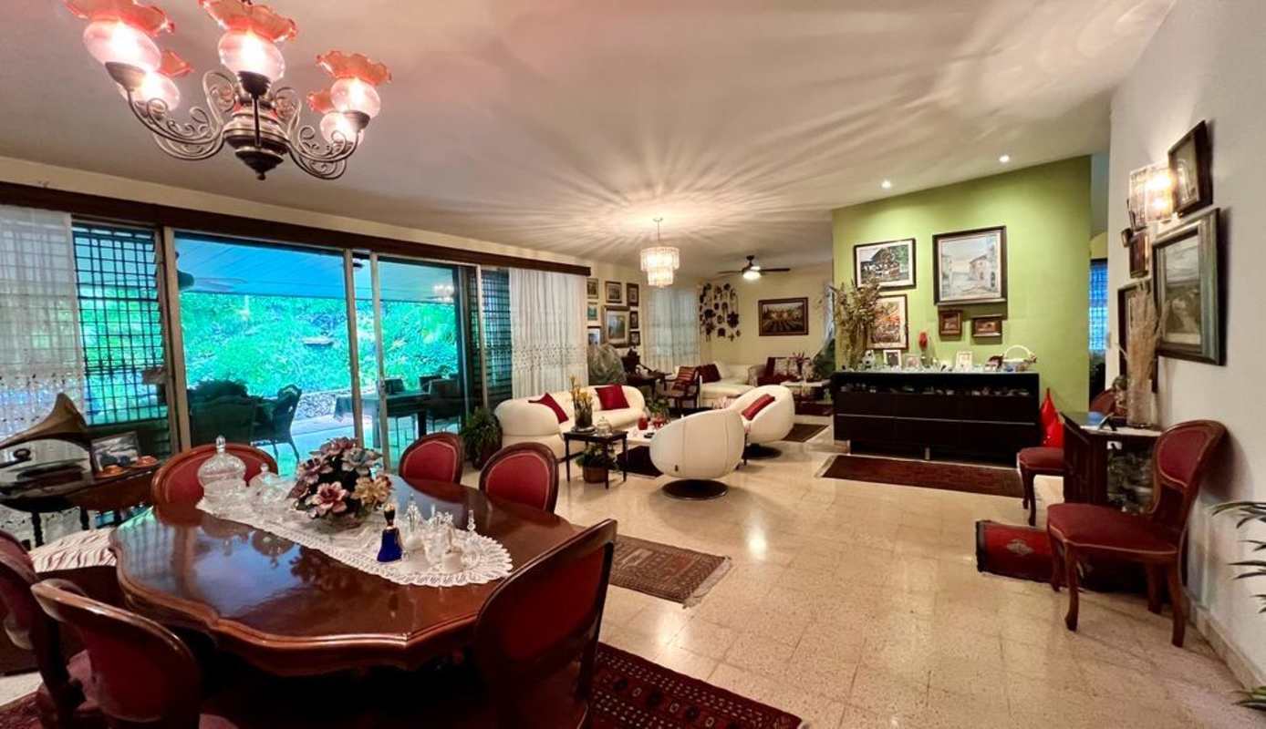 Covered terrace with outdoor dining, bar area, surrounded by greenery and gazebo Panama house