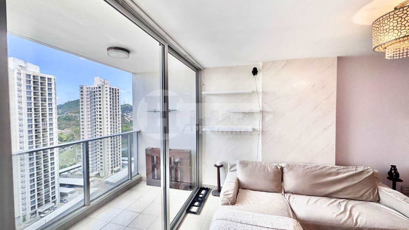 Modern open plan dining and living room with ample seating and natural light at PH Rokas Panama City