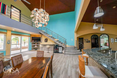 Double garage arched windows palm landscaping Mediterranean beachfront house in Playa Barqueta Panama