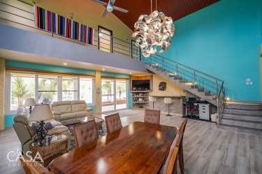 Double height living room balcony loft dining area ocean views at beach villa Las Olas Playa Barqueta Panama