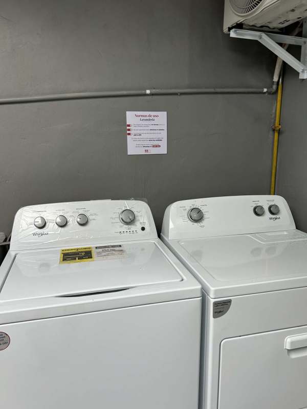 Shared laundry area with washer and gas dryer in Altos de San Ángel studio apartment Panama