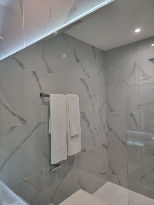 Modern bathroom with glass shower enclosure and sleek vanity in PH The Walker apartment Panama City