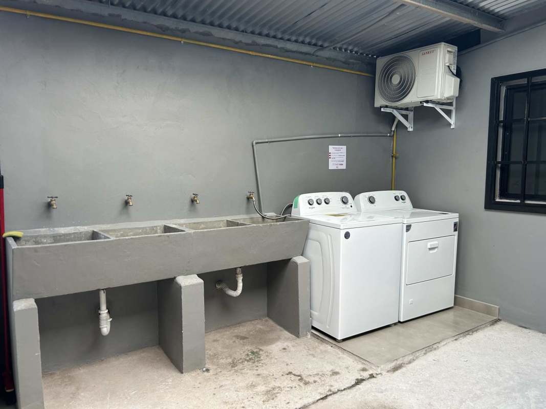 Kitchenette in studio apartment with granite countertop, gas stove, refrigerator and window Tocumen Panama