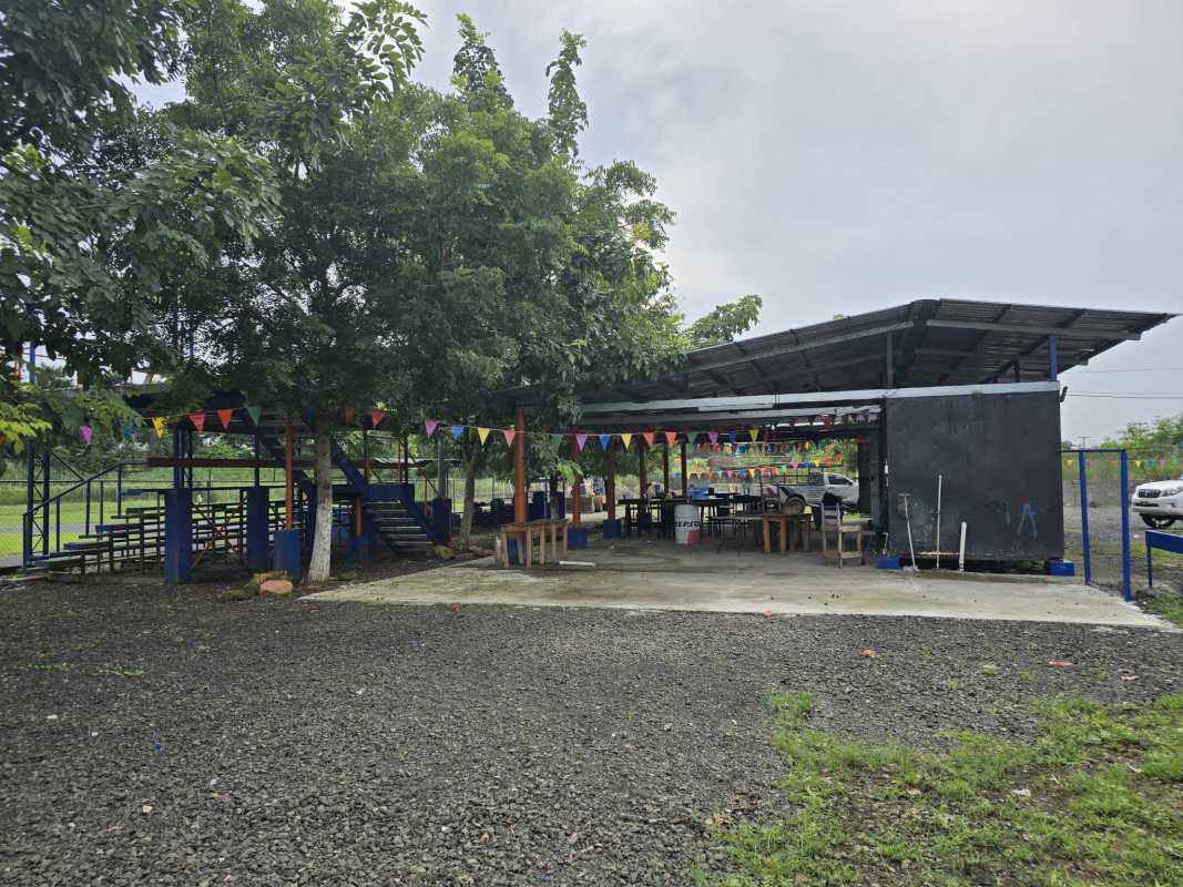 Wide covered recreational space with benches colorful flags Pacora Panama