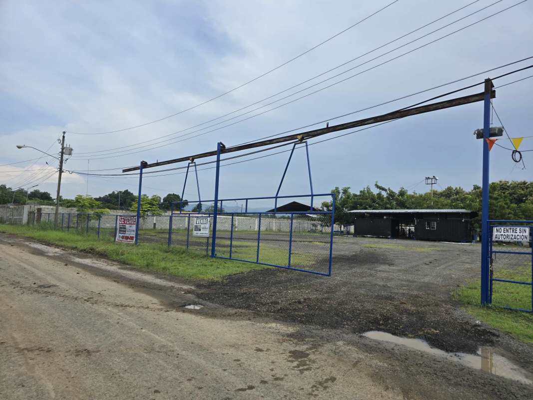 Large gravel parking and storage lot enclosed by wall and fencing Pacora Panama