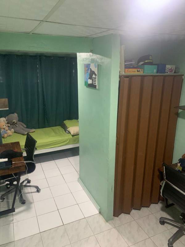 Modest bedroom or office with tiled floor window and desk Villa Zaita house Panama