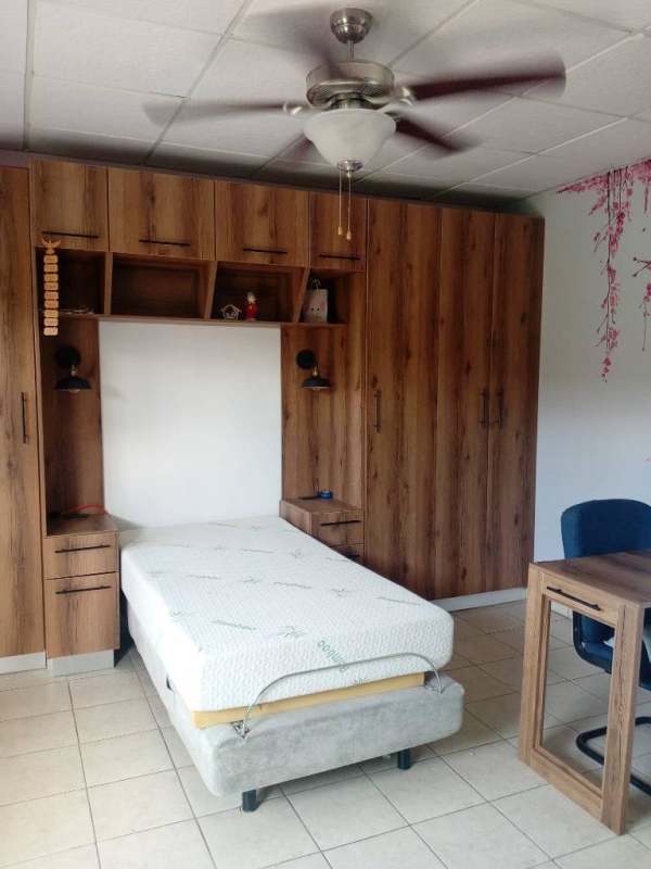 Studio bedroom with large wardrobe, desk and wall art Chanis Parque Lefevre Panama