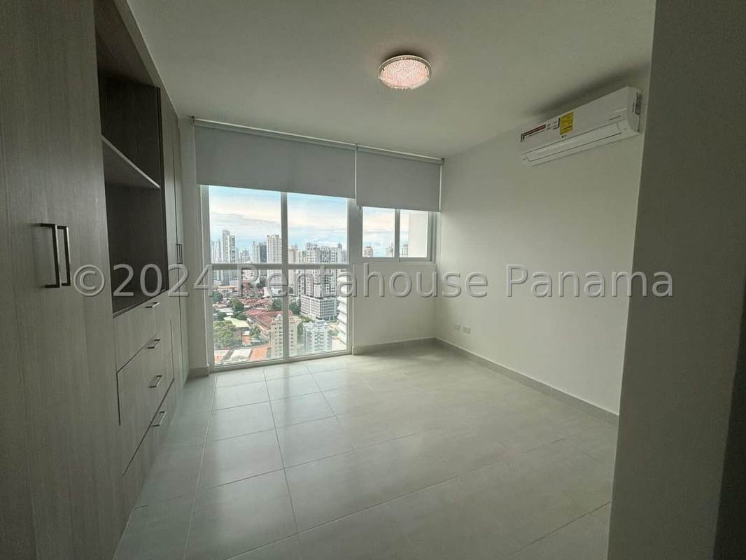 Living room with ceramic tile floor, balcony access, city view in Obarrio Panama City apartment