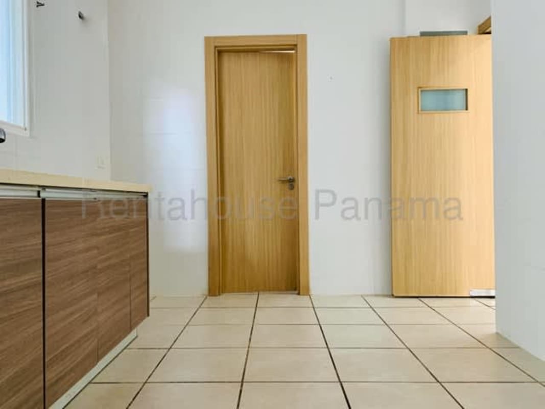 Kitchen with wooden cabinetry and ceramic tile flooring PH Victoria Brisas del Golf Panama