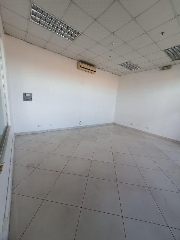 Interior commercial office with white tile floors and partition walls at Plaza Tocumen