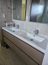Contemporary bathroom with tile, modern sink and mirror in Nativa house Panama