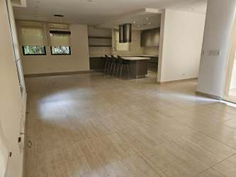 Bright living-dining open plan area with tiled floor and garden view in Panama Pacifico home for sale