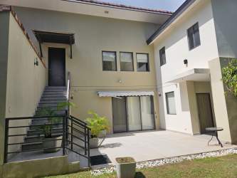 Facade of contemporary house with balcony and garden in Nativa Panama Pacifico