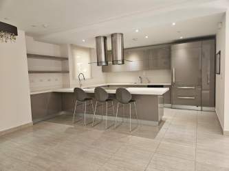 Modern granite kitchen with island and stainless steel appliances at Nativa house in Panama Pacifico