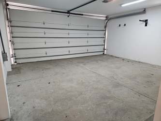 Contemporary bathroom with beige tiles, large mirror and double sink vanity in Nativa house