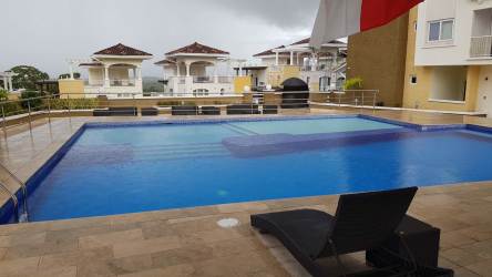Infinity swimming pool lounge chairs Tucán Country Club community Panama Pacifico