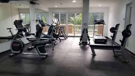 Modern gym with fitness equipment windows natural light in Tucán Country Club Panama apartment complex