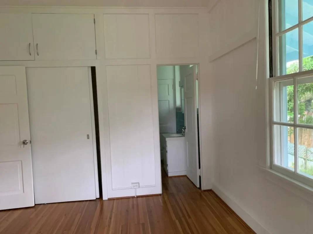 White minimalist kitchen with subway tile backsplash and wood floors house for sale in Los Rios Panama