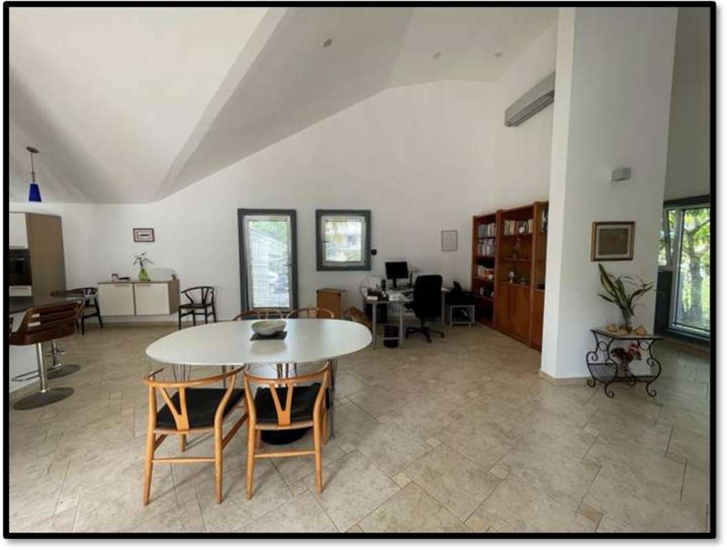 Contemporary bedroom with blue accent wall, vaulted ceiling, wood furniture in spacious Clayton home Panama