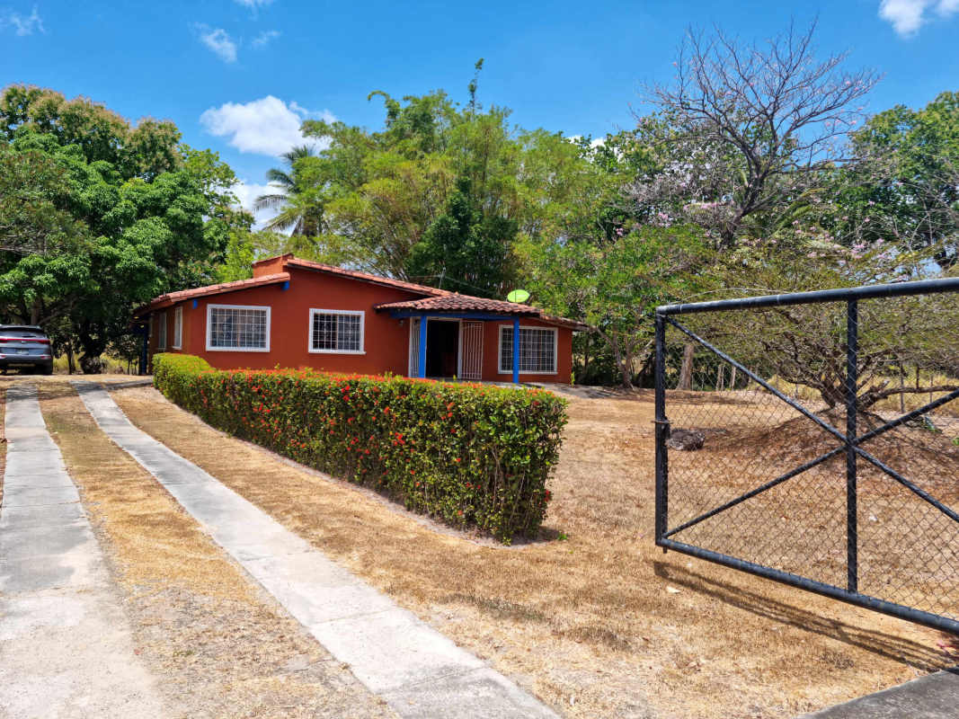 Gated orange ranch home with terracotta roof and large yard in Chilibre Panama land parcel
