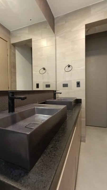 Double sink bathroom with modern black fixtures and elegant tiling luxury condo Panama