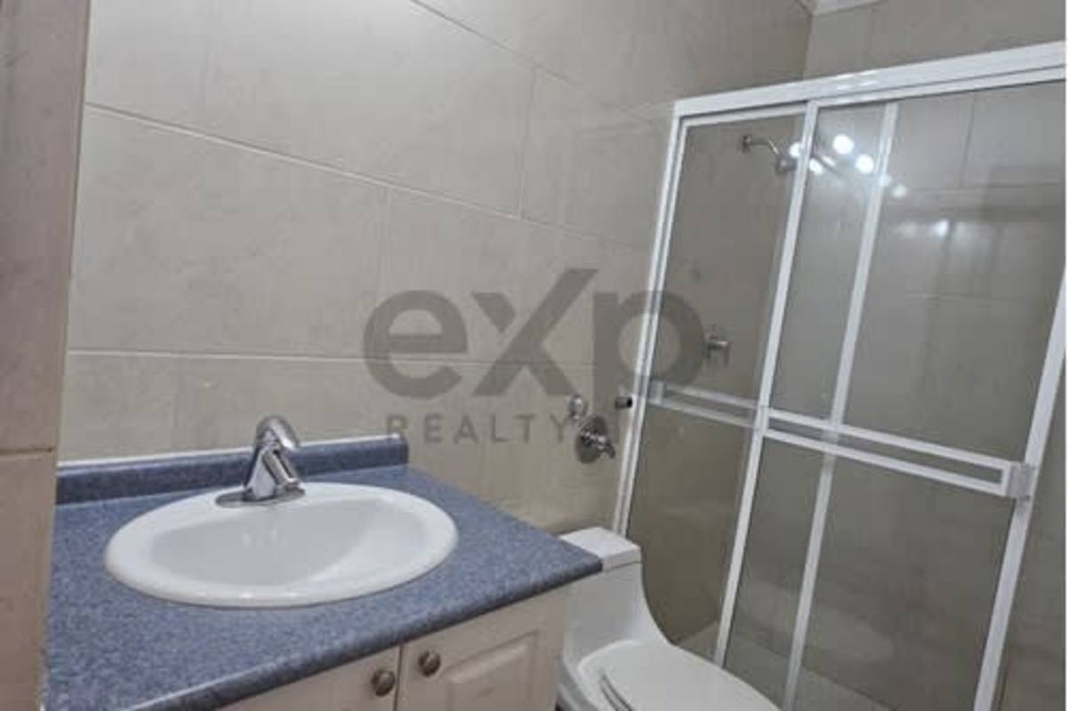 Contemporary bathroom with tiled walls, glass shower enclosure in Victoria Tower Obarrio Panama City