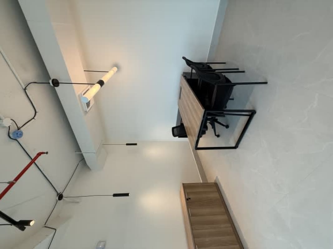 Modern minimalist office with exposed ceiling, wooden desk, black office chairs in PH Prisma Business Tower Costa del Este Panama