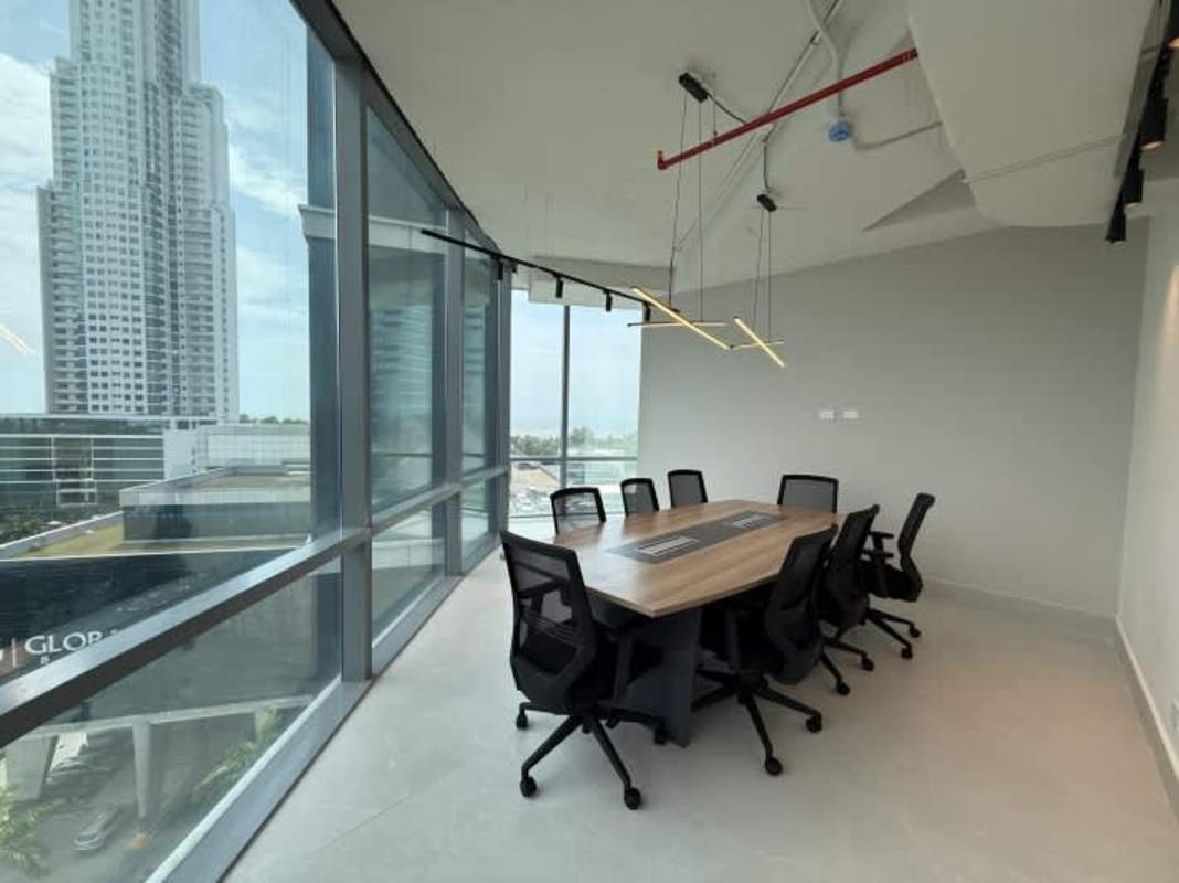 Conference room with large windows, wood table, pendant lighting at PH Prisma Business Tower Costa del Este Panama