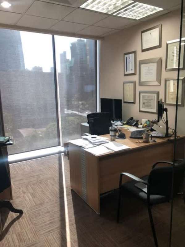 Open-plan modern office workspace with cubicles and glass partitions Office One Tower Obarrio