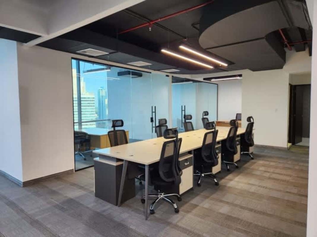 Modern office with glass partitioned executive offices large windows city skyline Costa del Este Panama