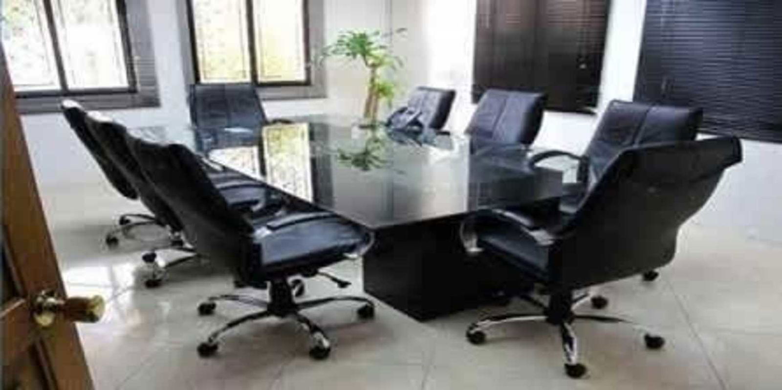 Bright conference room with glass-top table and black leather chairs commercial space Panama City