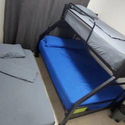 Bedroom with bunk bed and twin bed, tile floors in furnished Coronado beach rental Panama