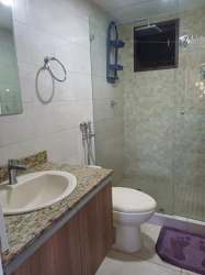 Contemporary bathroom with tiled walls, shower, vanity and mirror at PH Coronado Golf Apartment