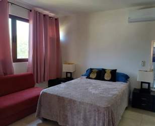 Modern bathroom with granite countertop vanity, glass shower enclosure and tiled walls in PH Coronado Golf Beach apartment Panama