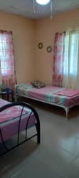 Cozy bedroom with air conditioning, ceiling fan, yellow decor Penonomé Coclé Panama