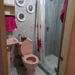 Bathroom with pink fixtures, walk-in shower and tile details Penonomé Coclé Panama