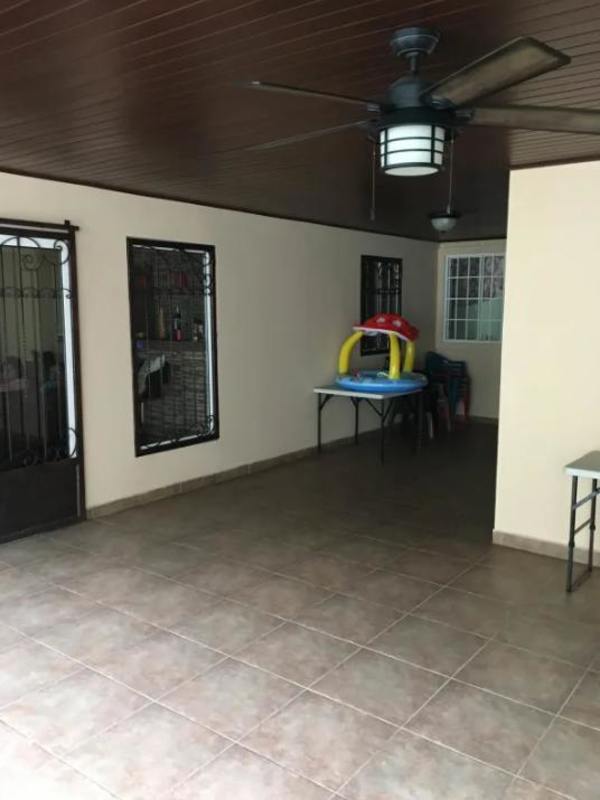 Modern kitchen with built-in oven, gas stove, tile backsplash and wood cabinets in duplex house Brisas del Golf Panama