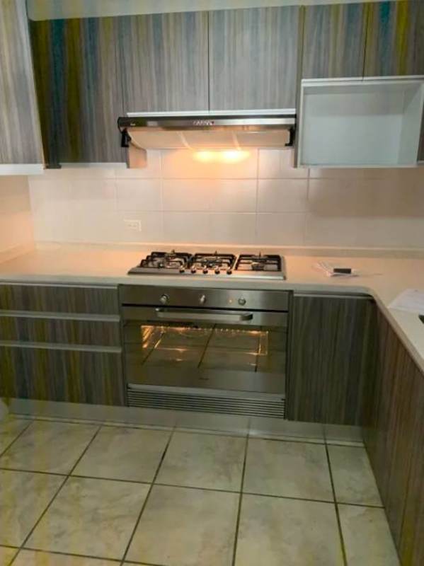 Small bathroom with blue tile walls, shower, pedestal sink and mirror duplex in Brisas del Golf Panama