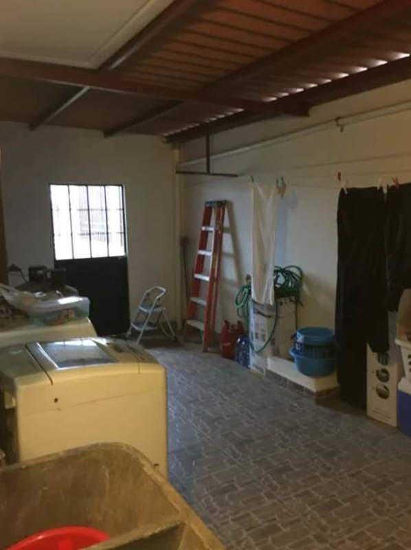 Multipurpose laundry and storage area with washing machine in house for sale Brisas del Golf Panama