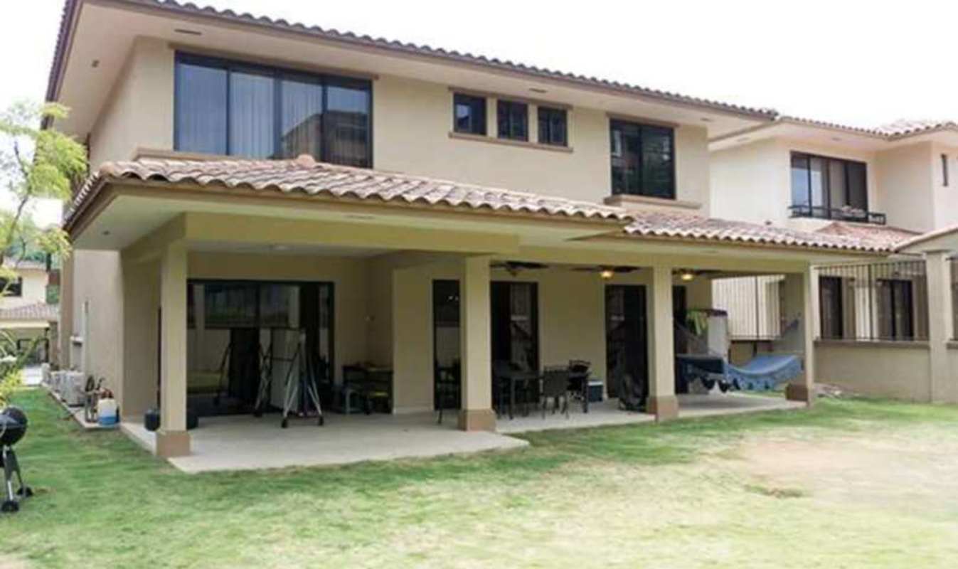 Two-story Mediterranean home with tiled roof, pool, covered patio and lawn in Clayton Panama