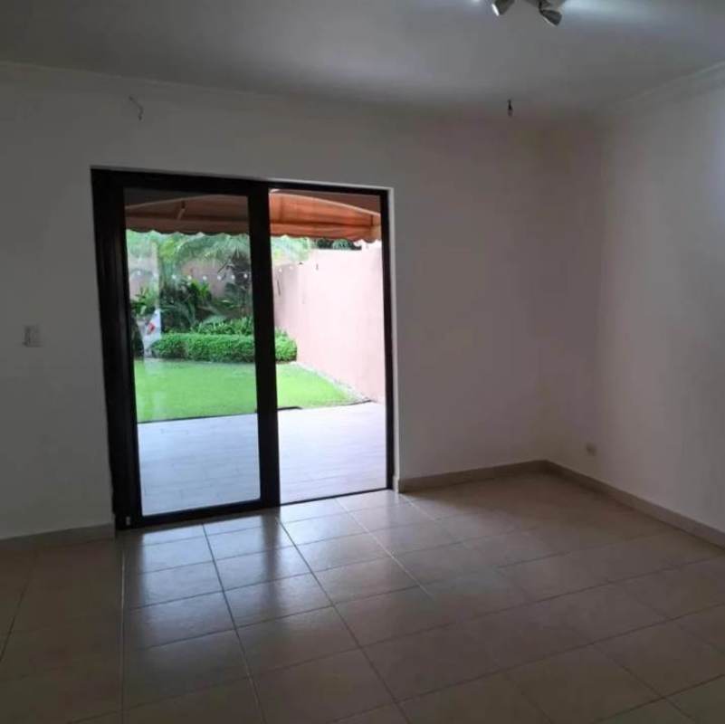 Spacious living room with sliding doors opening to private garden terrace in PH Versalles Panama