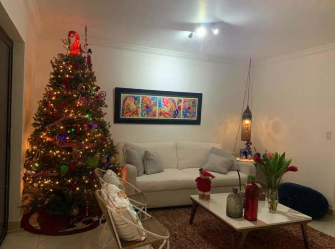 Decorated living room with holiday accents and large windows in PH Versalles Panama City