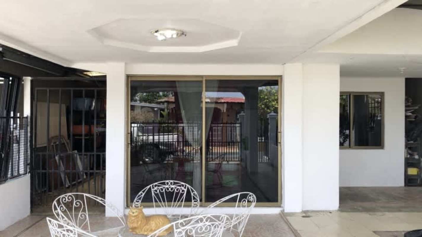 Living room with floor-to-ceiling glass doors, ceramic tile floors in Vacamonte house