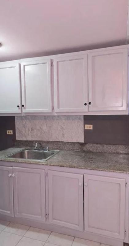 Compact kitchen with granite countertop, marble backsplash PH Parque Lefevre Panama City