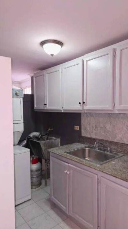 Compact apartment interior with kitchen, stacked washer dryer PH Parque Lefevre Panama City