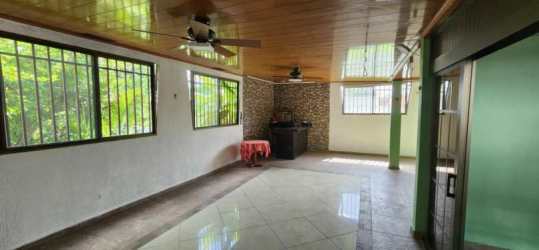 Spacious room with wood ceiling, stone wall and fans at Santa Clara Panama beach home for sale